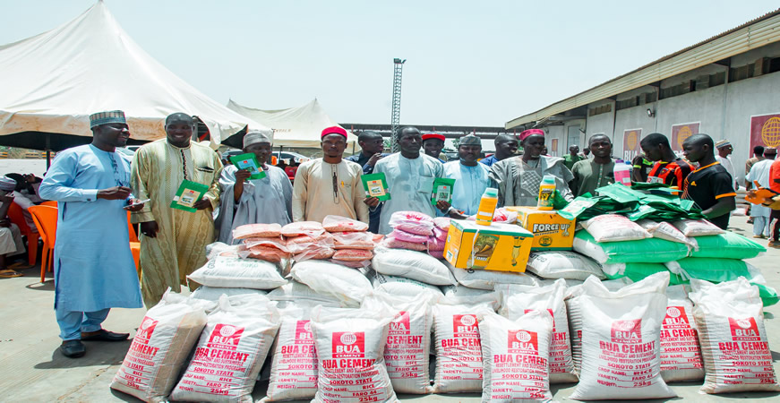 Beneficiaries display farm inputs received under BUA Cement's livelihood restoration programme